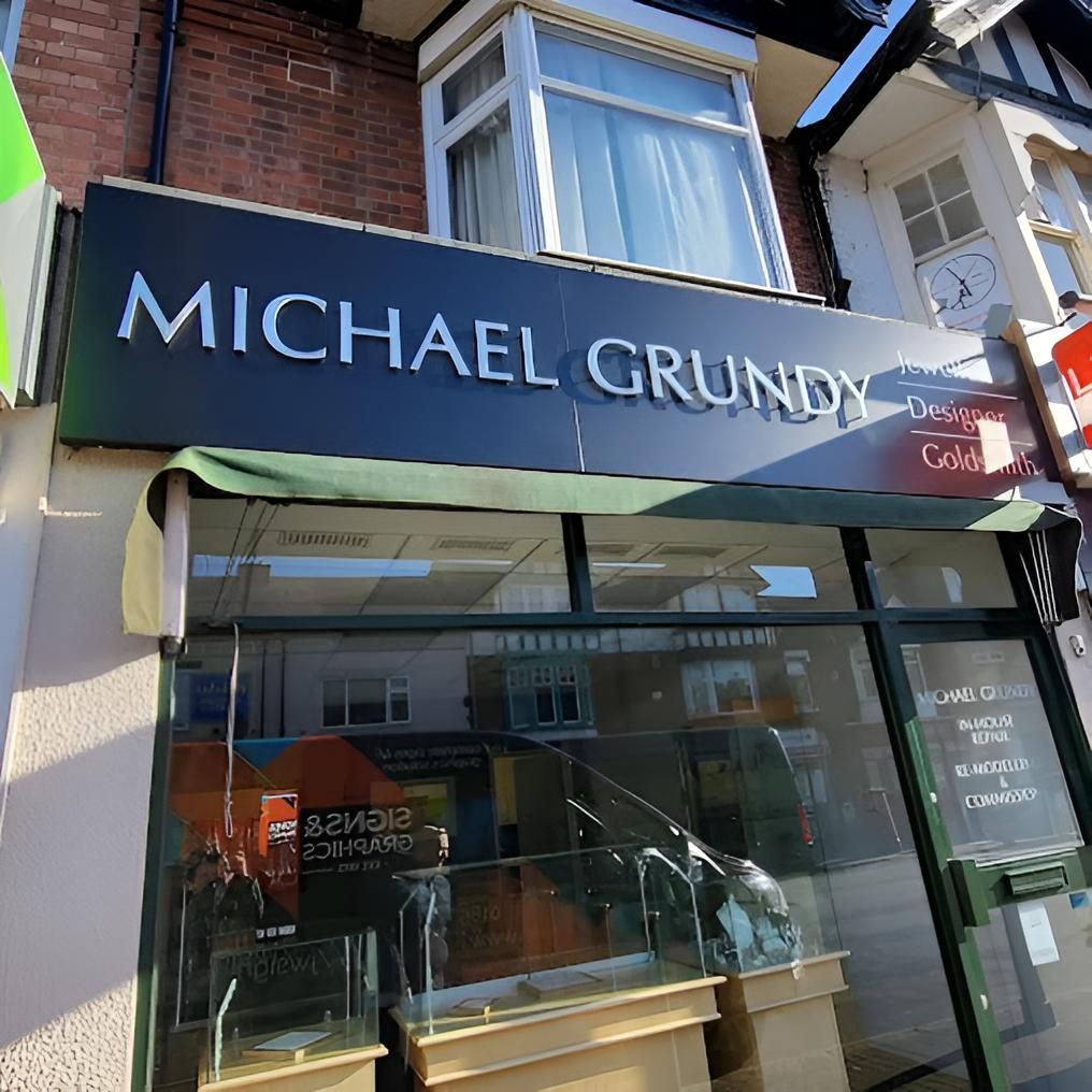 A Store Front With A Sign That Says Michael Grundy — JW Signs and Designs In Brisbane, QLD