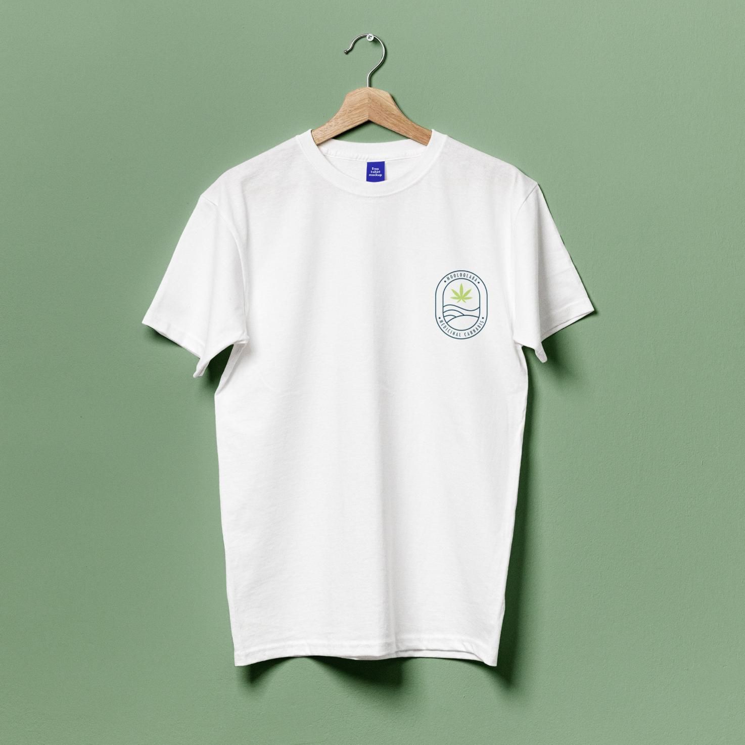 A White T-shirt Is Hanging On A Wooden Hanger — JW Signs and Designs In Mount Isa, QLD