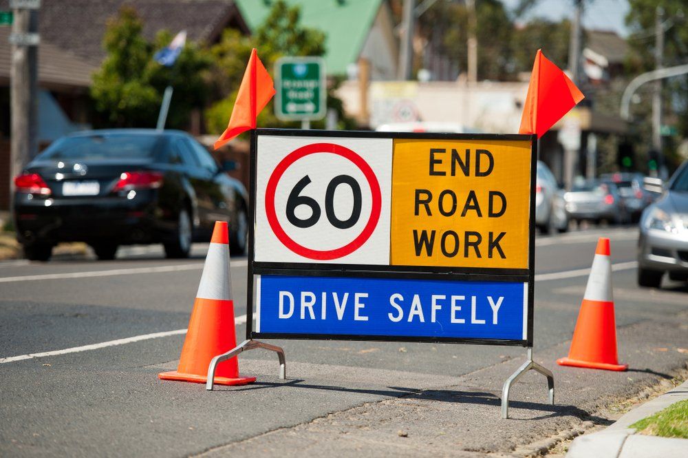A Sign On The Side Of A Road That Says End Road Work Drive Safely — JW Signs and Designs In Mount Isa, QLD