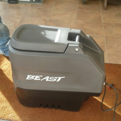 Gray BEAST portable appliance on a tiled floor, with a black base and power cord attached.