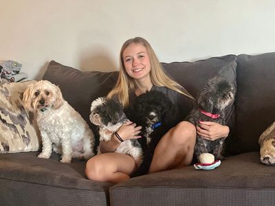 Ruffin' Around employee with her pack of dogs.