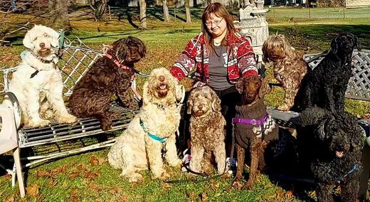 Ruffin' Around employee with her pack of dogs.