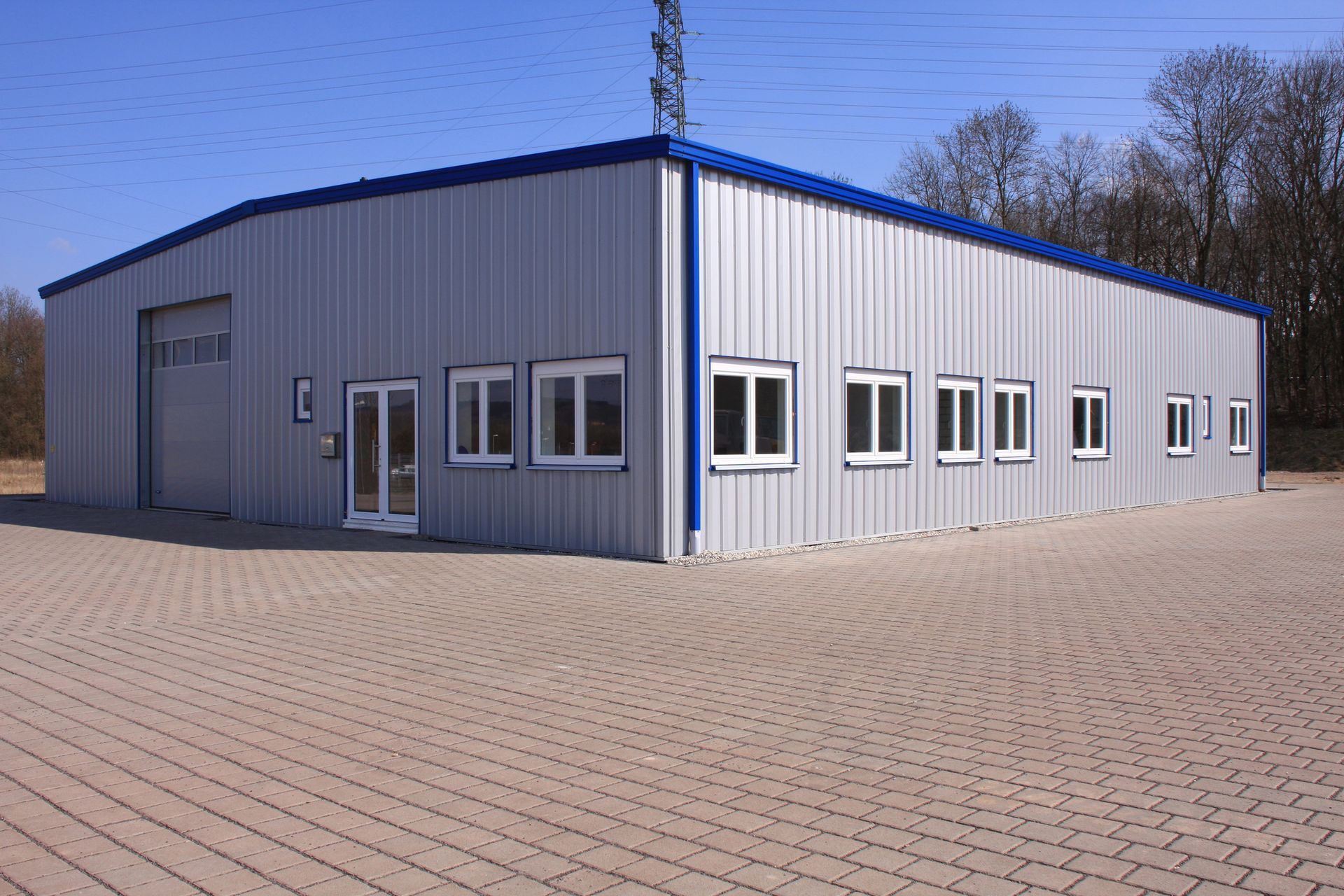 A large building with a blue roof and a lot of windows A large building with a blue roof and a lot of windows
