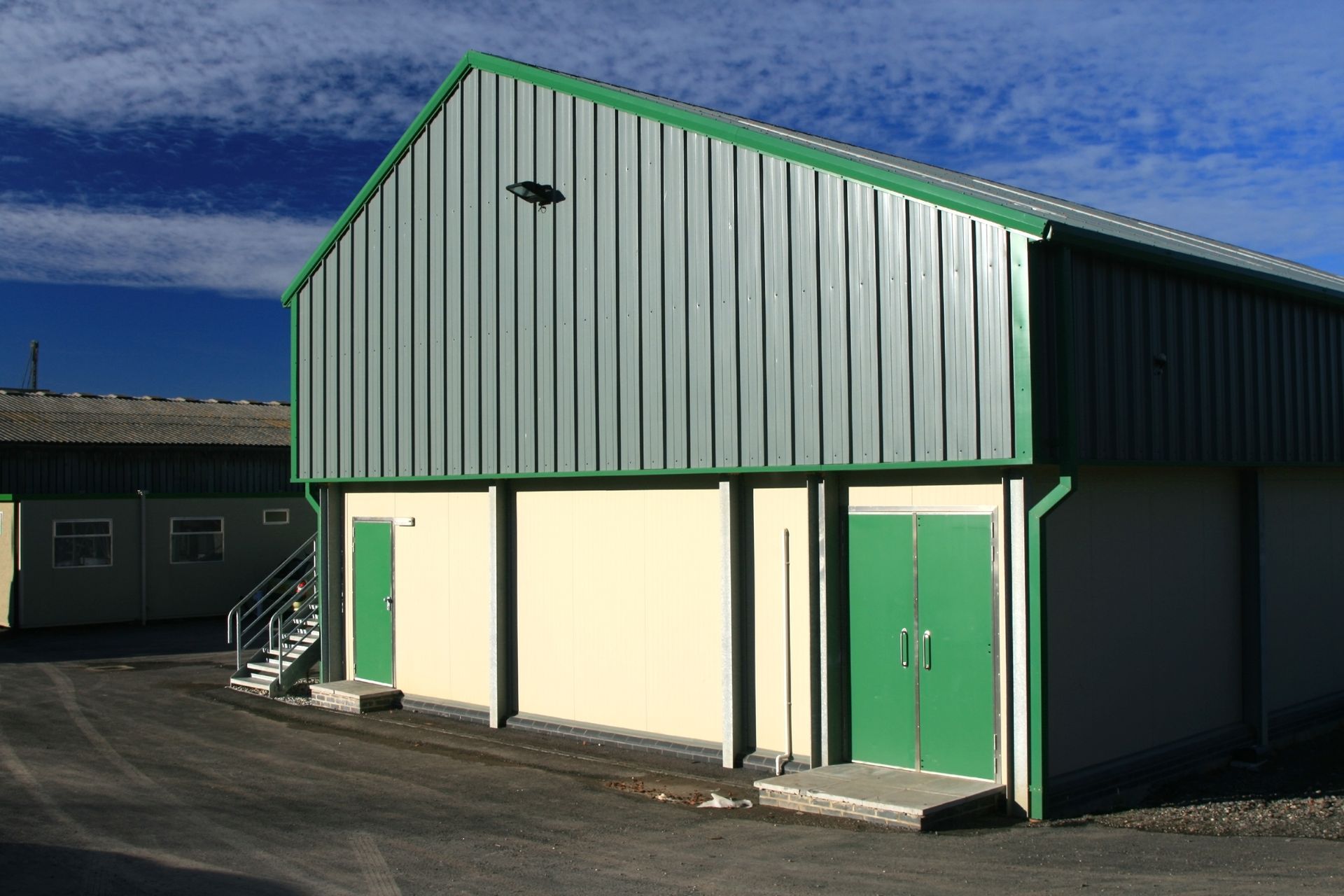 A building with a green roof and green doors A building with a green roof and green doors