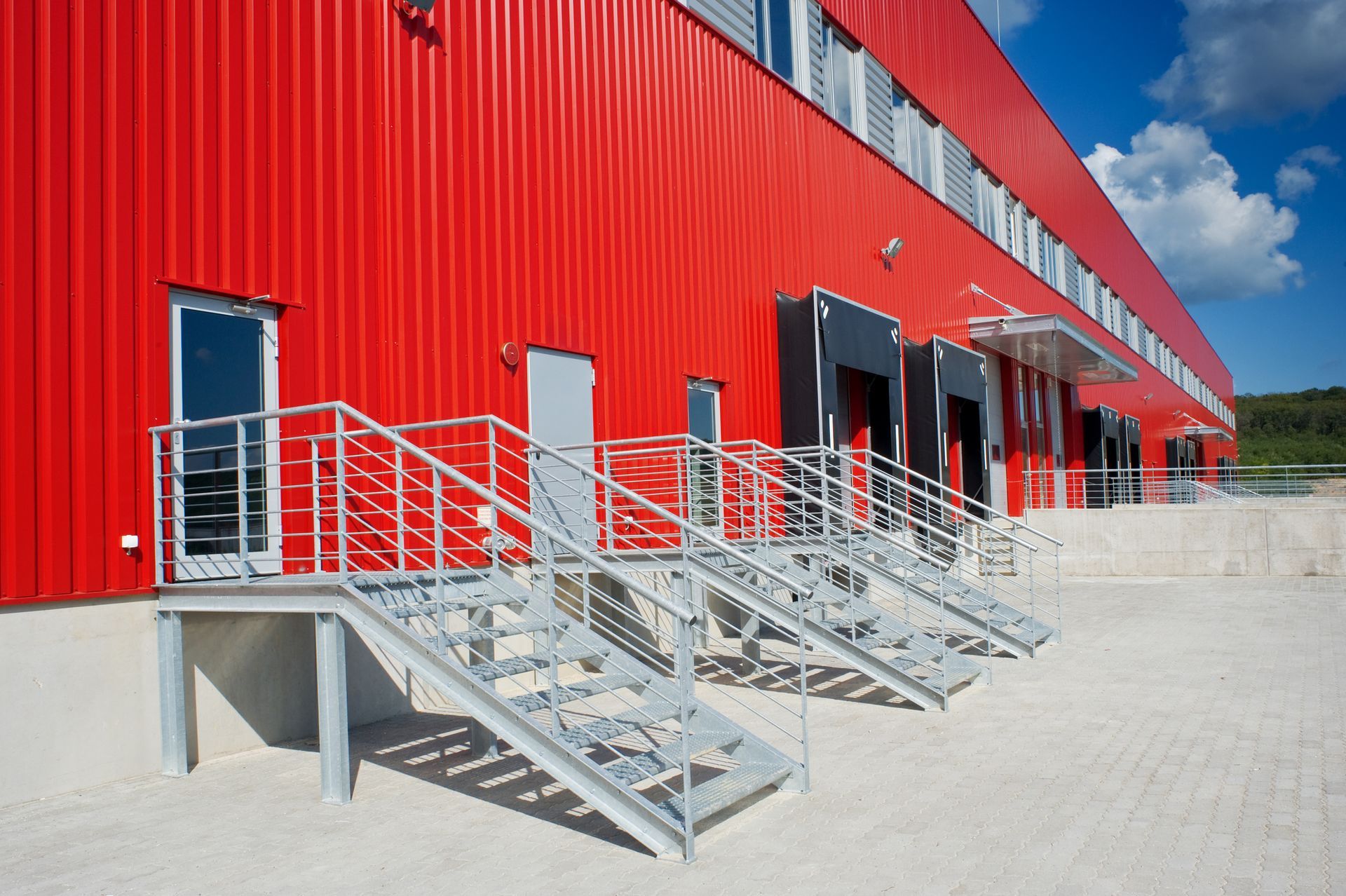 A red building with stairs leading up to it A red building with stairs leading up to it