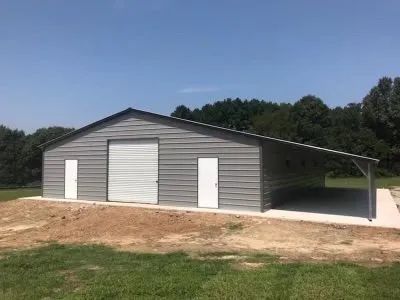 A large metal building with a carport attached to it.