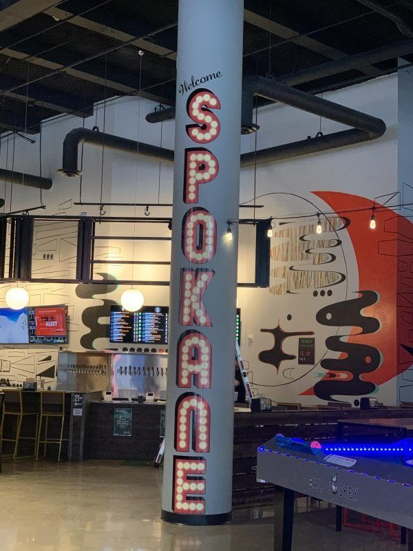 A vertical, light-up sign reading 