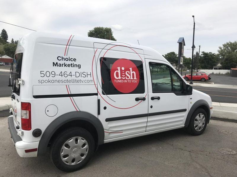 A white van parked outdoors, branded with the Dish logo, Choice Marketing, and a phone number on its side.