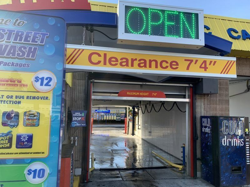 A car wash entrance with a bright green 