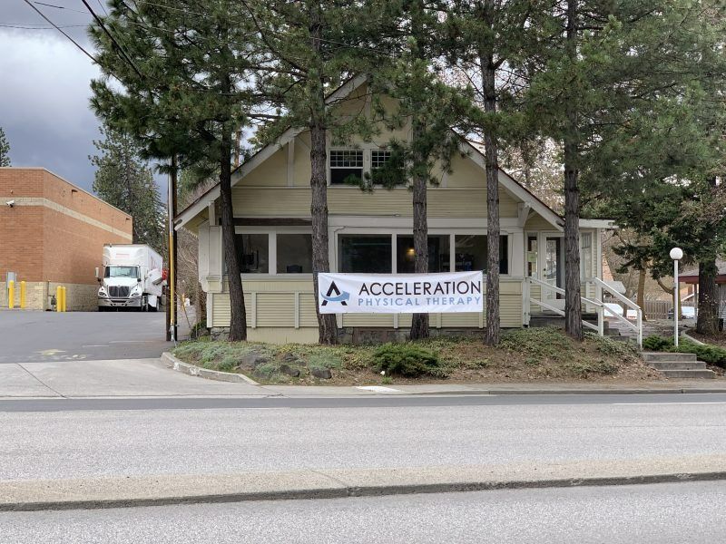 A cream-colored building with a banner reading 