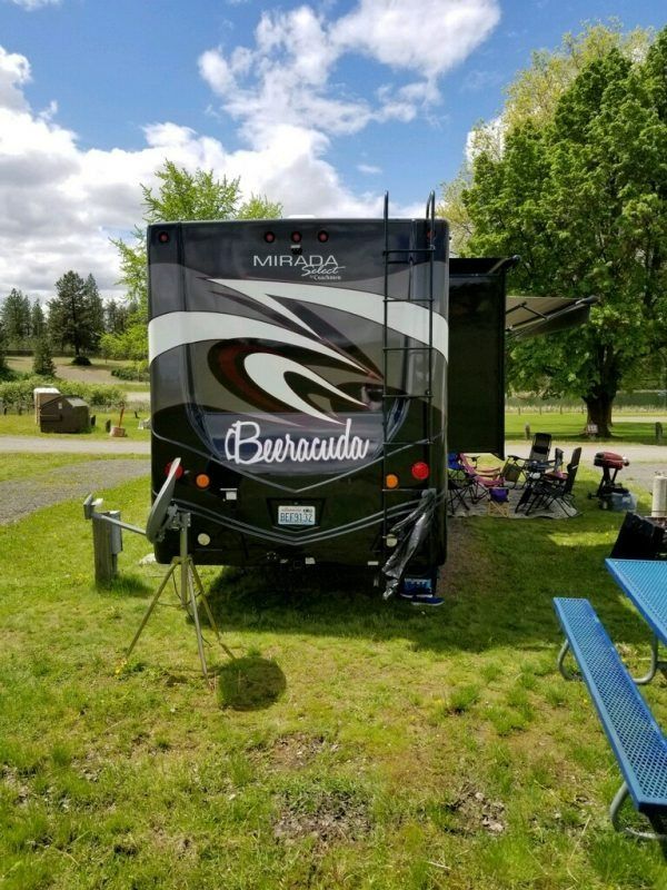 Rear view of a black and gray Mirada motorhome labeled 