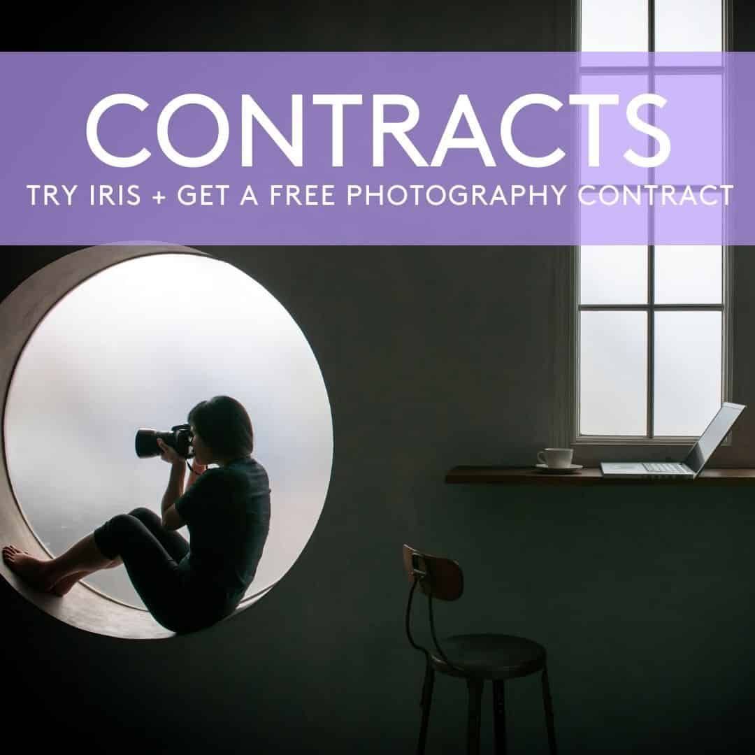 A woman is sitting in a circle taking a picture with a camera under a sign that says contracts