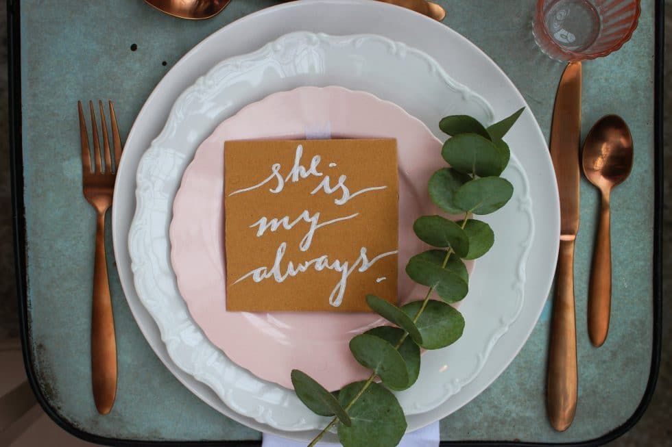 A place setting with a napkin that says she is my always