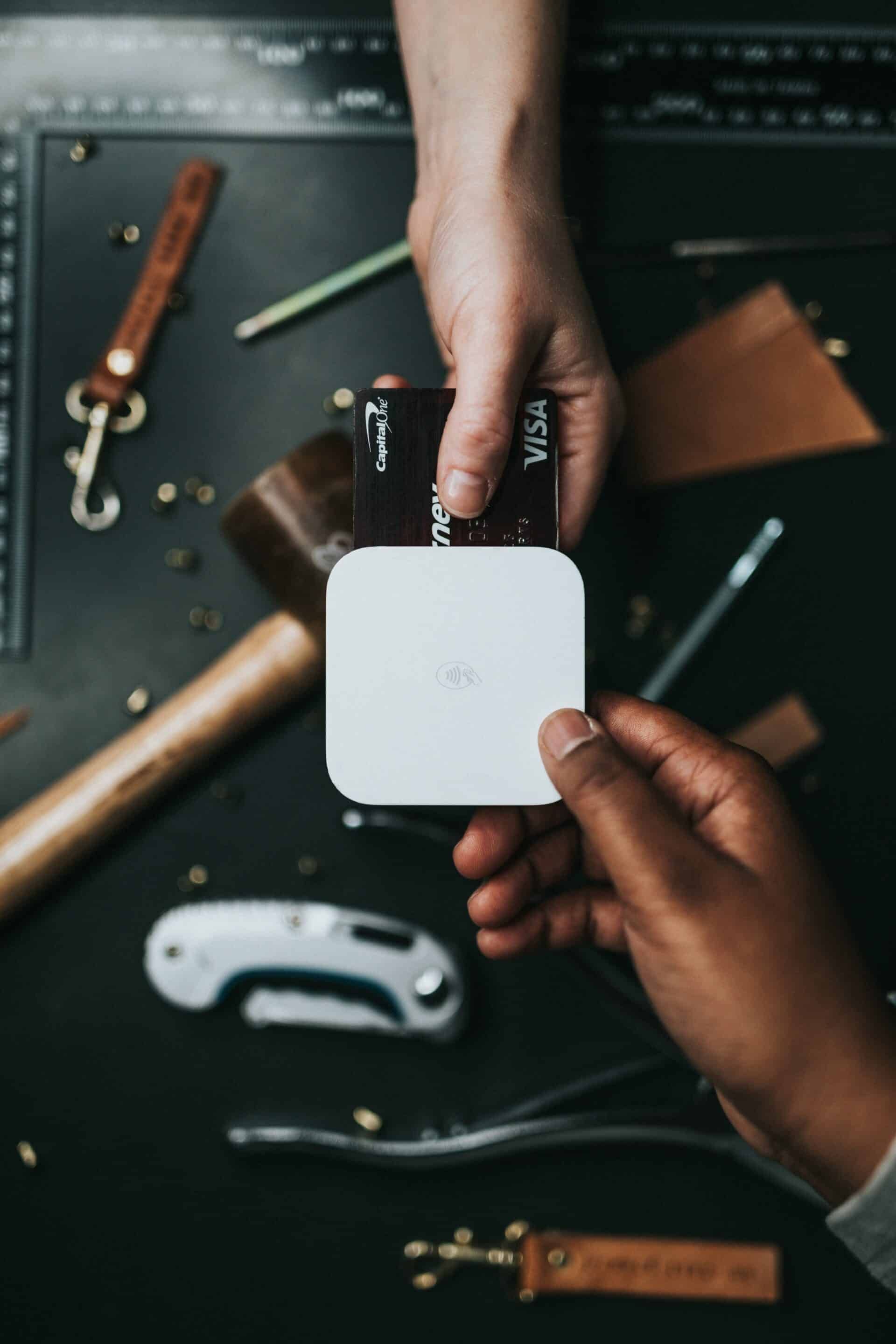 square invoicing A person is holding a credit card in their hand.