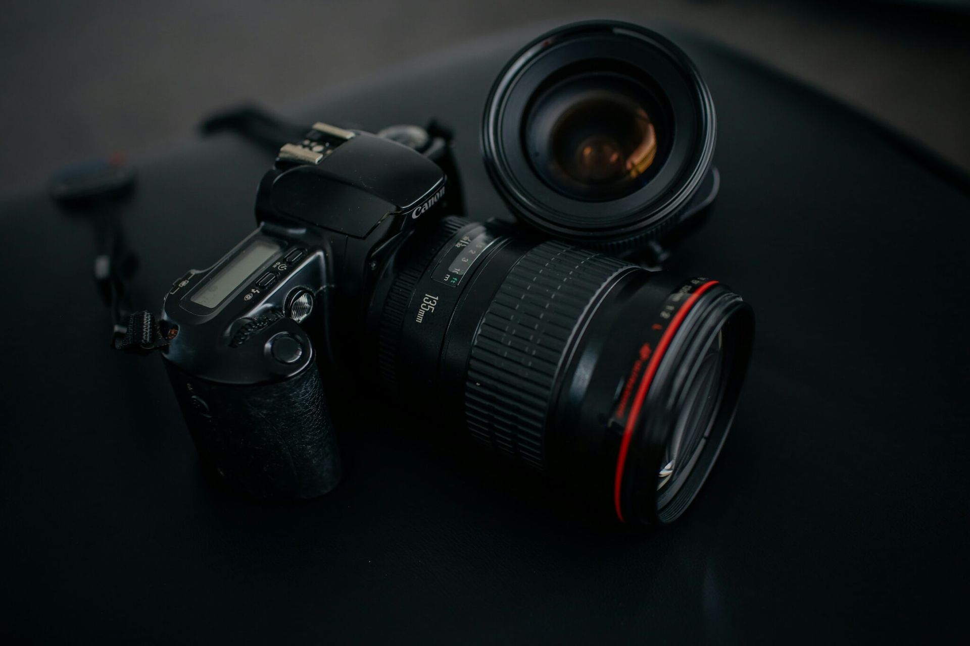 A close up of a camera and lens on a table.