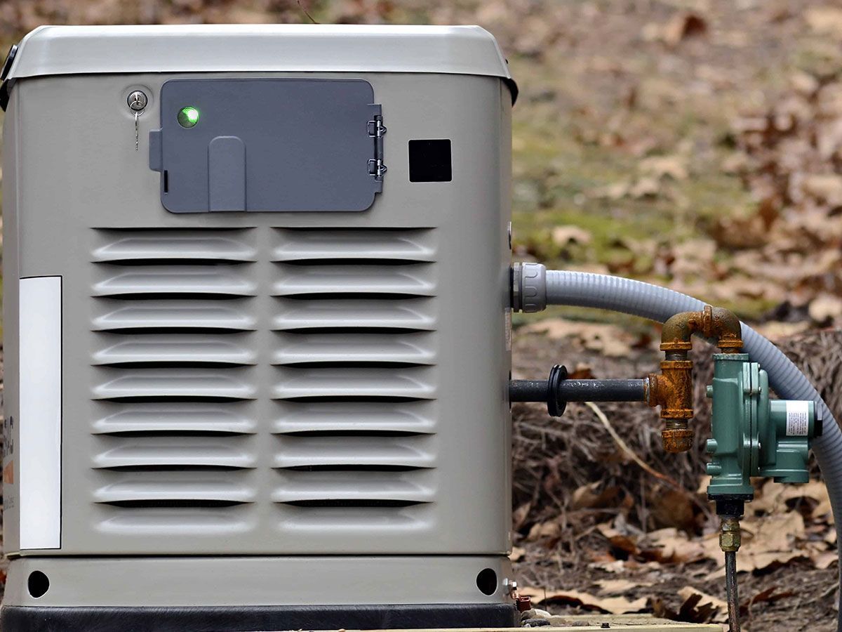 A generator is connected to a water faucet outside.