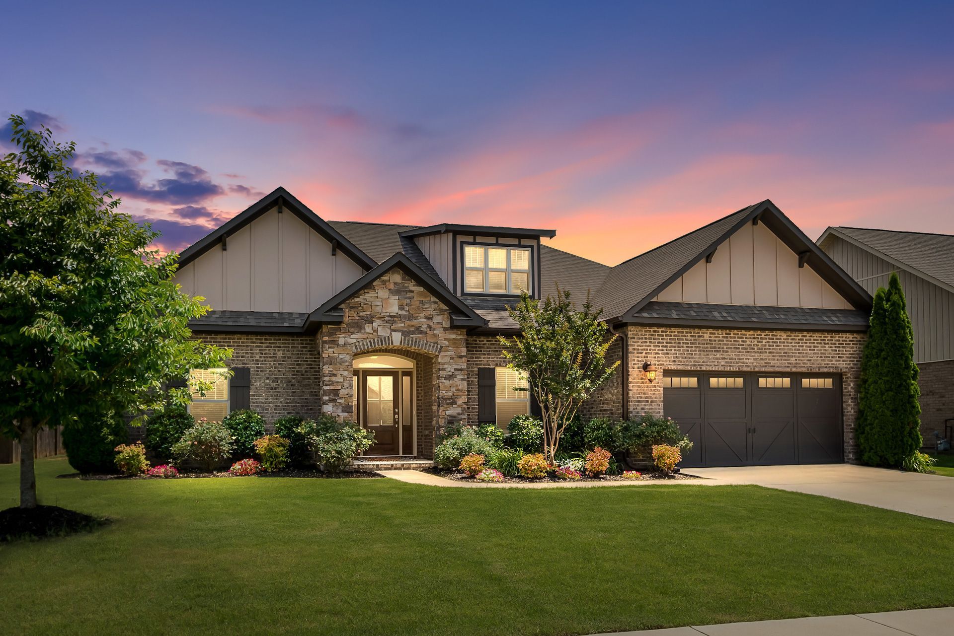 A large house with a sunset in the background