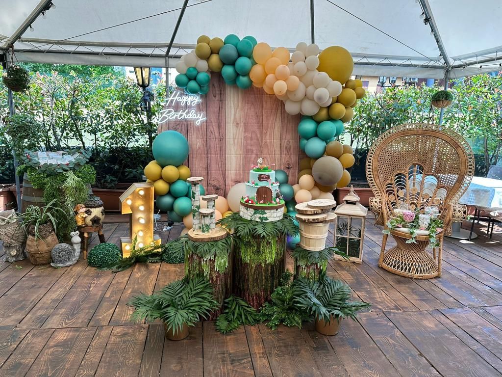 Allestimento per festa di compleanno a tema fiabesco. Include torta, palloncini e decorazioni rustiche.