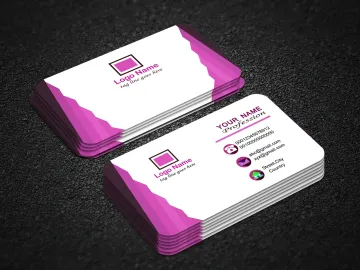 Stack of business cards with a green and white design on a wooden surface. One card is face up.
