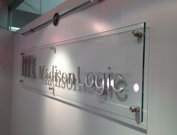 Clear sign with metallic lettering reading 