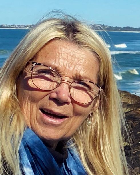Sandie smiling by the ocean