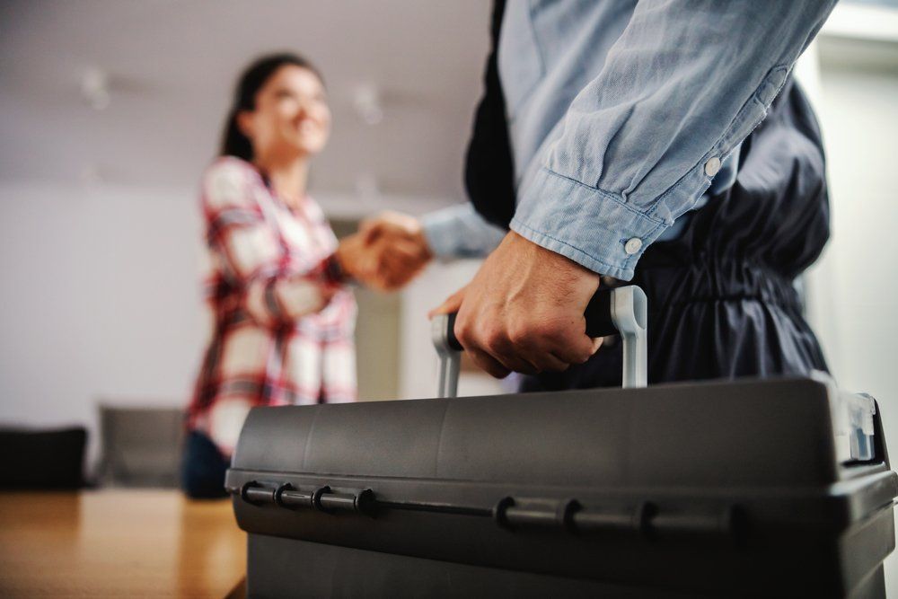 Woman Shaking Hands With A Plumber