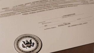Close-up of an official stamped document with typed text and a circular seal on a desk.
