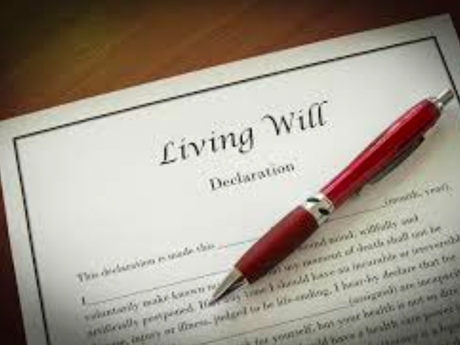A red pen is sitting on top of a living will.