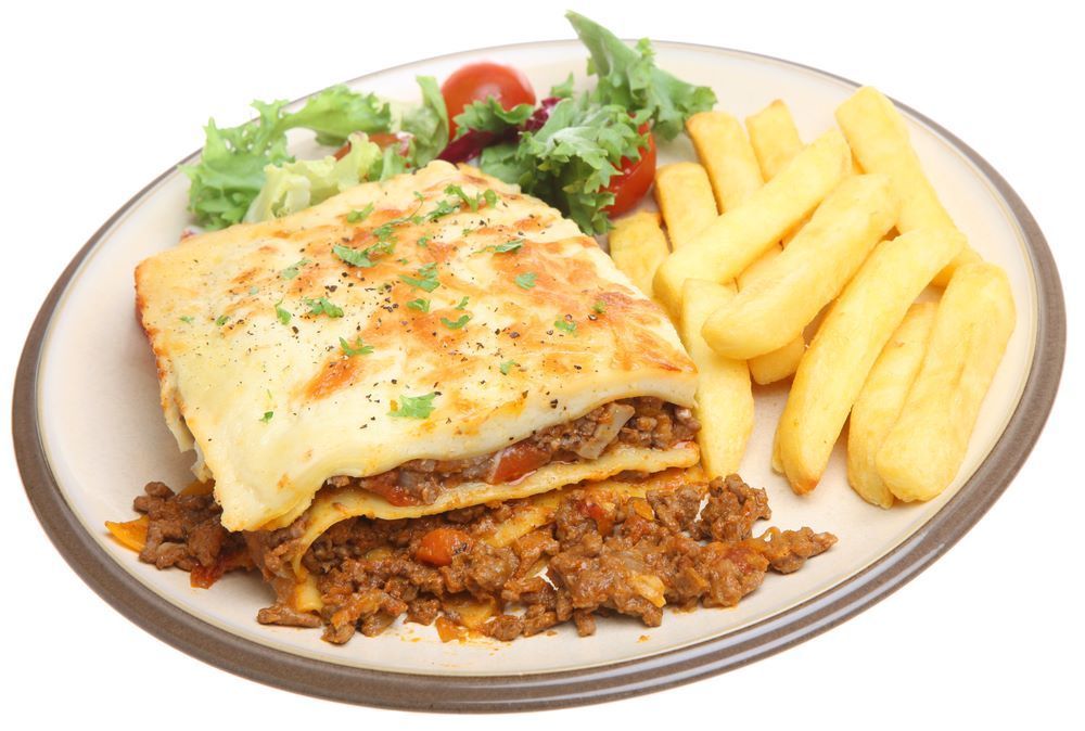 A Plate of Lasagna and French Fries on a White Background — Michelangelos Pizza & Pasta in  Kelso, NSW