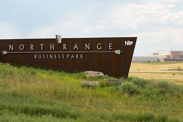 NorthRange Business Park sign in a grassy field under a cloudy sky