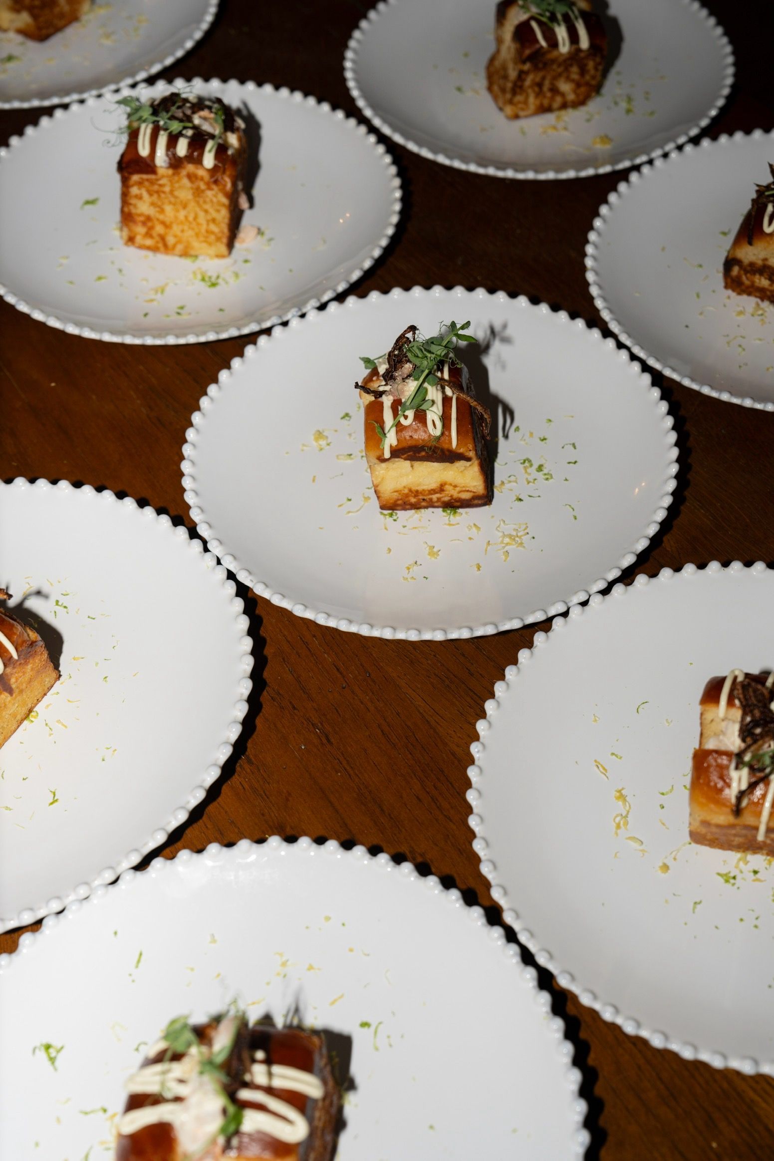 A row of wooden chairs sitting in front of a long table