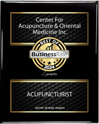 A black and gold plaque for center for acupuncture & oriental medicine inc