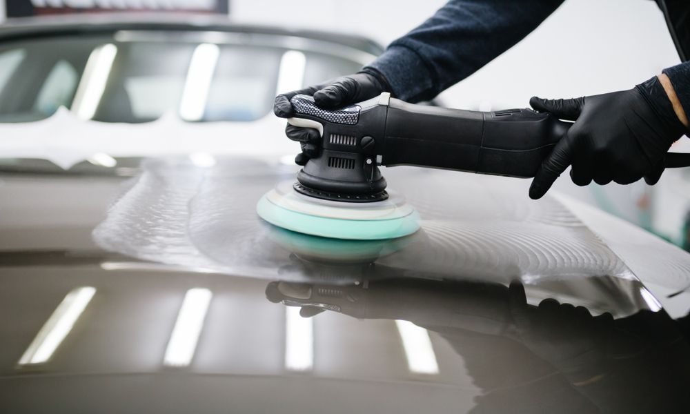 Person in Black Gloves Using a Polisher on a Car's Hood, Leaving Swirls — Bob Kolln Automotive In Charmhaven, NSW