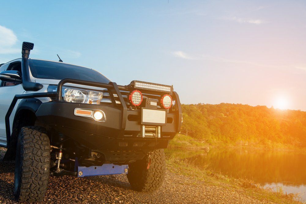 Off-road Vehicle's Black Axle and Suspension With a Red Rim — Bob Kolln Automotive In Charmhaven, NSW