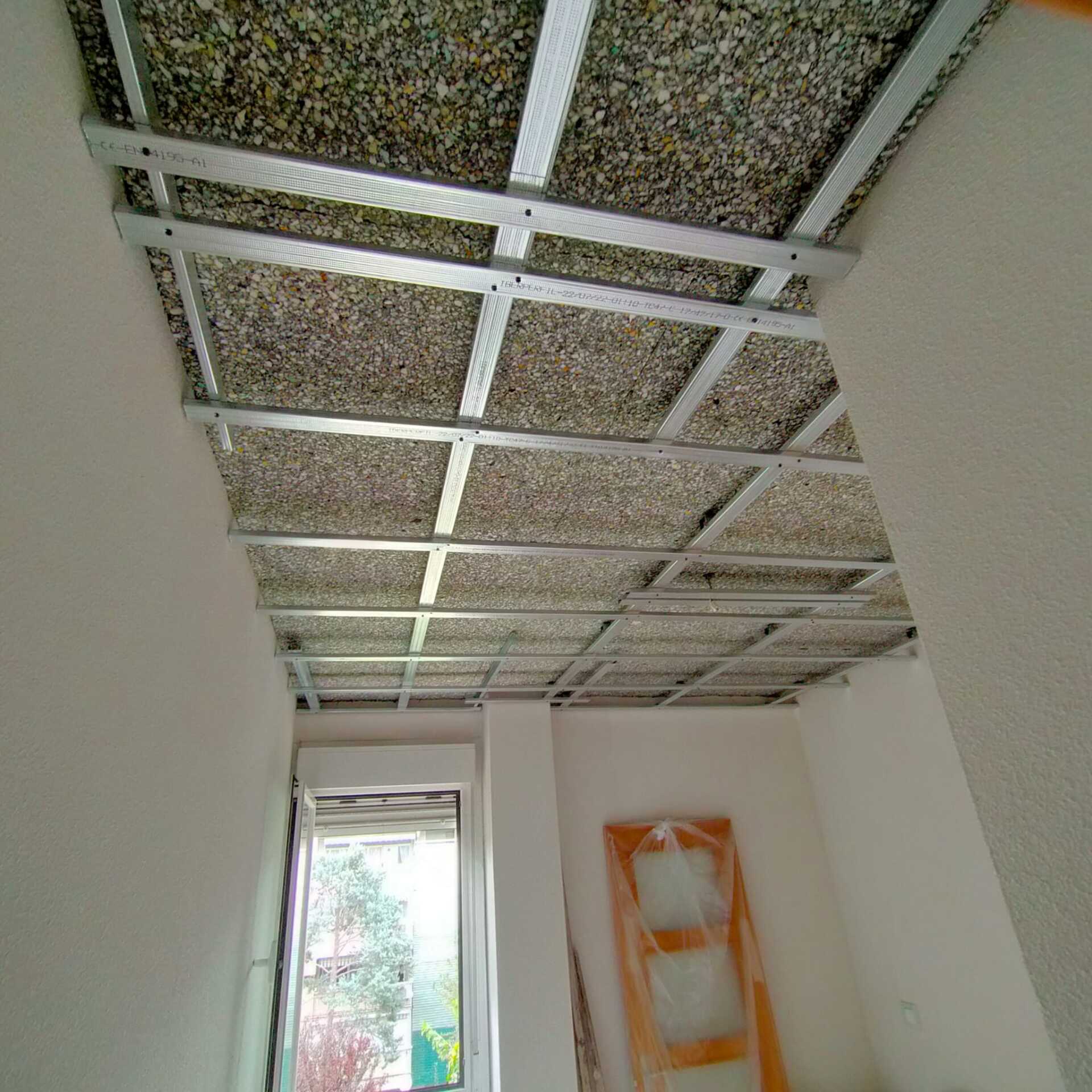 Una habitación con un techo que se está construyendo y una ventana.
