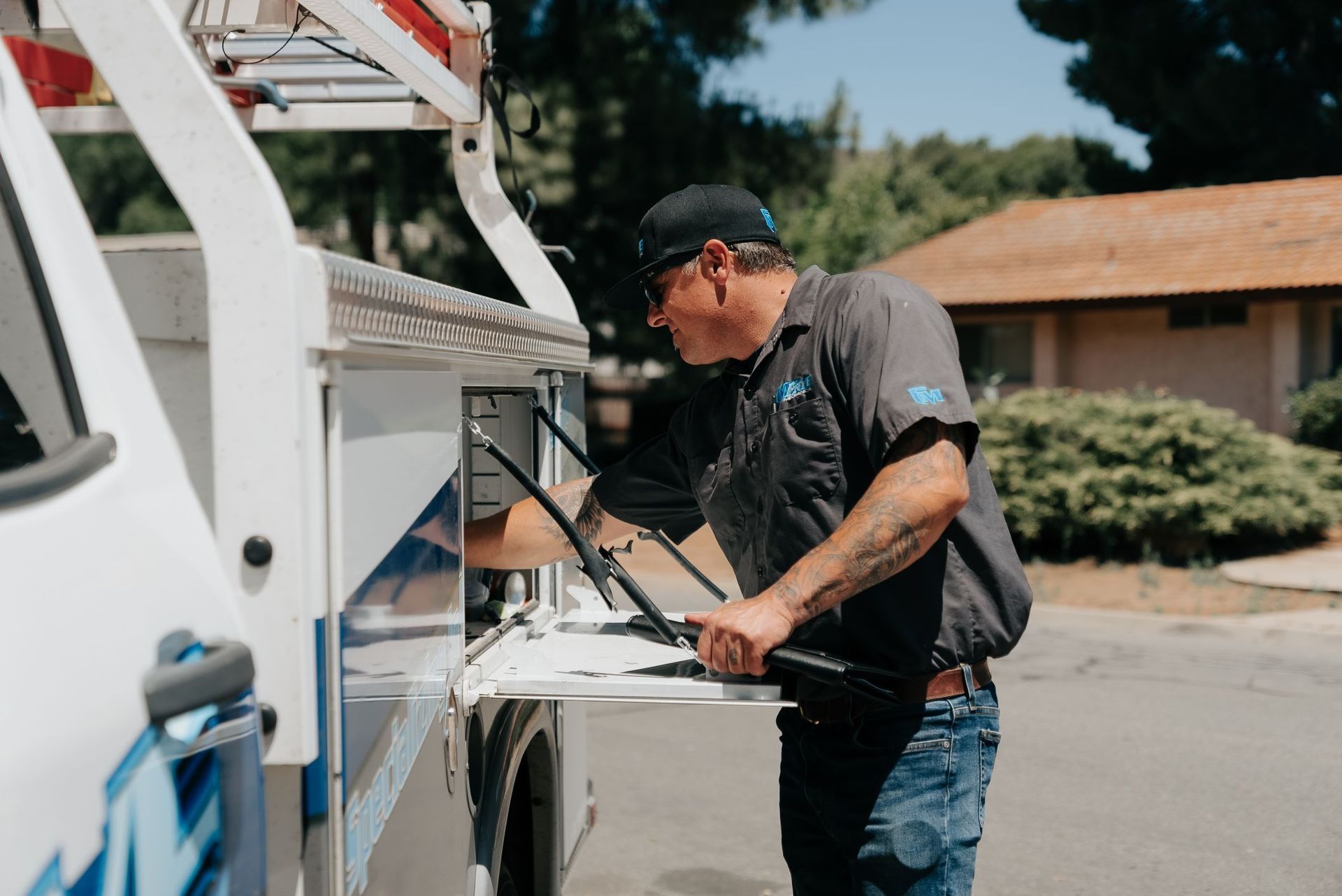 A man is working on a machine in the back of a truck.