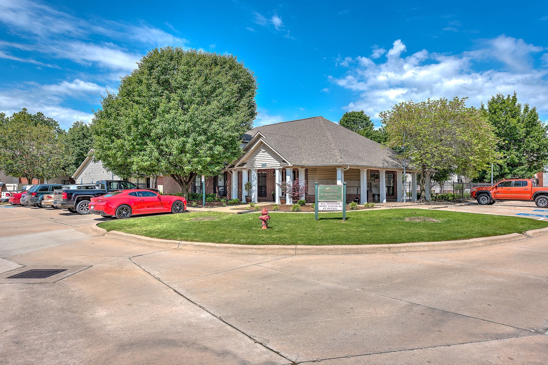 A house with a lot of cars parked in front of it
