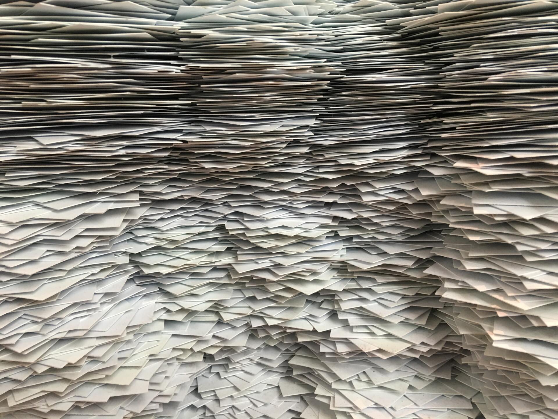 A large pile of paper is stacked on top of each other.