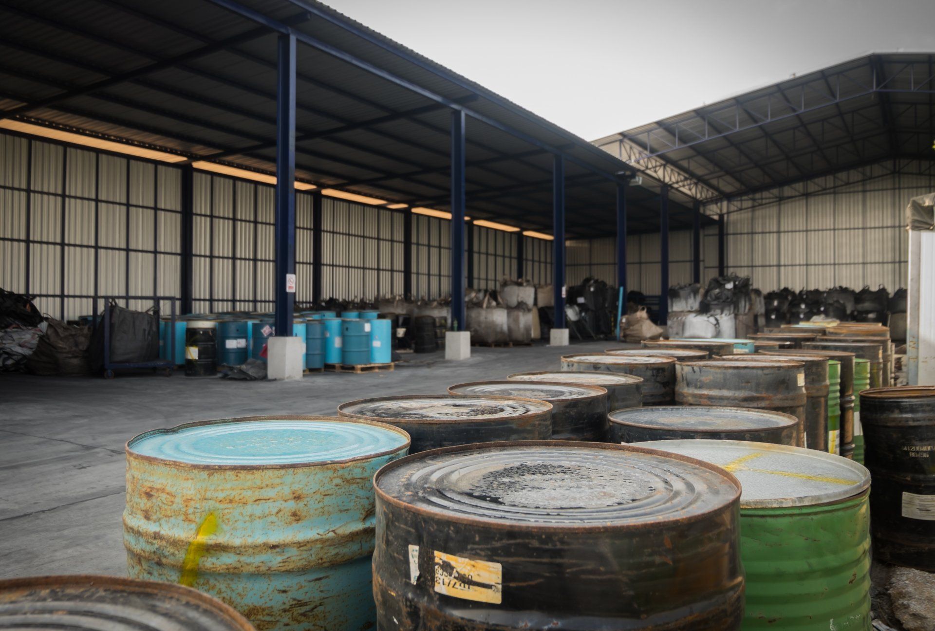 A warehouse filled with lots of barrels and containers.