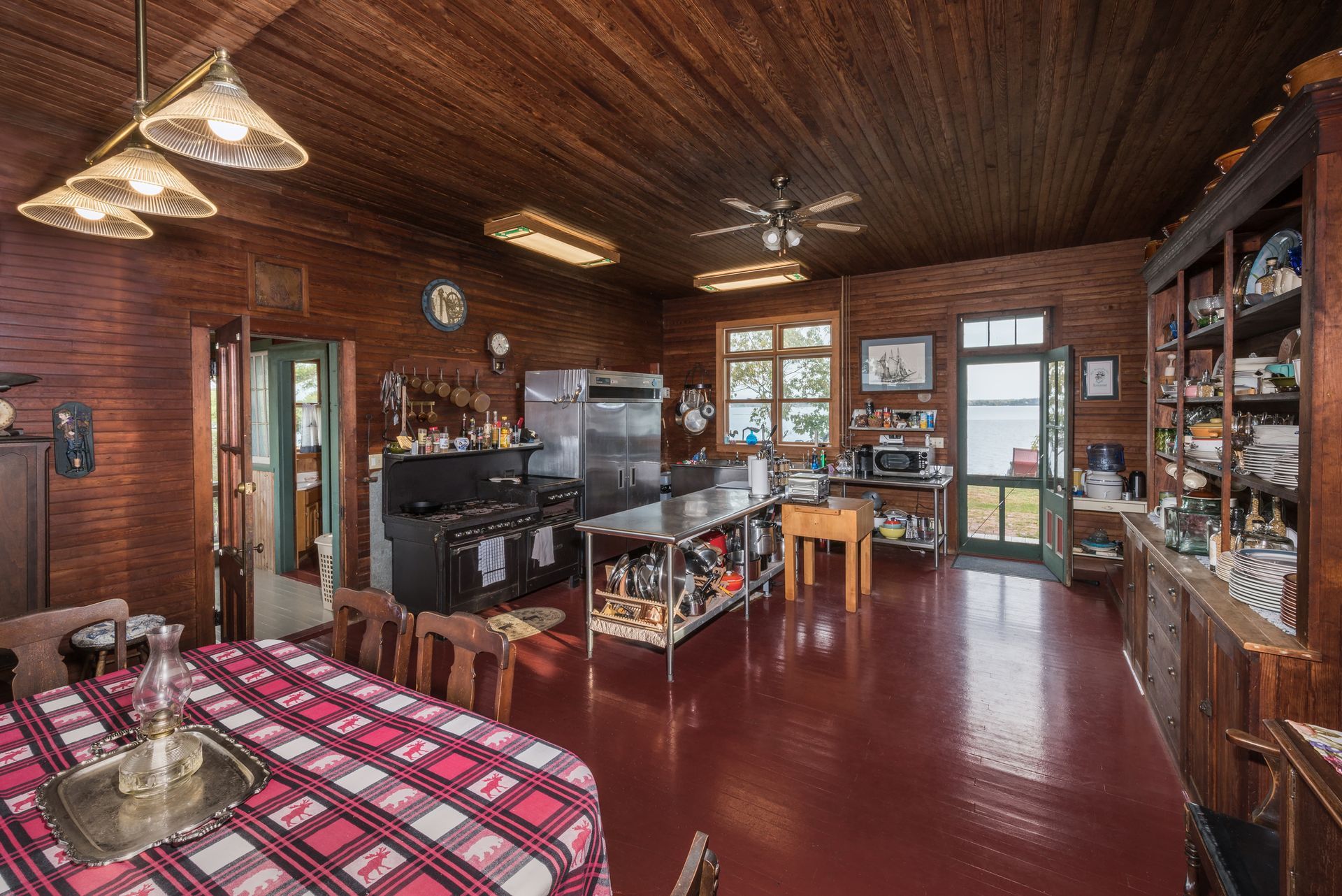 A kitchen with a table and chairs and a checkered tablecloth.