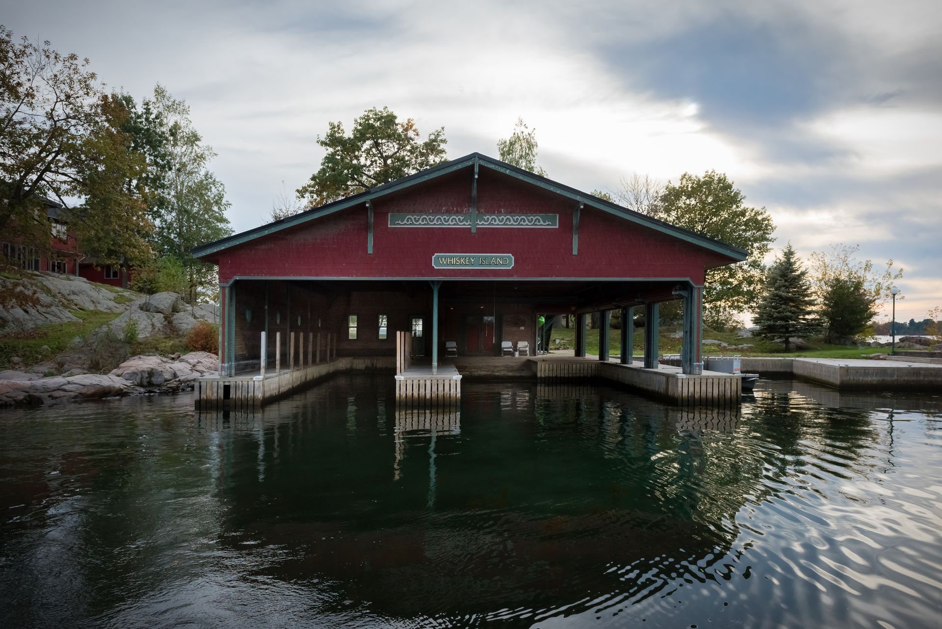 A large red building sits in the middle of a body of water