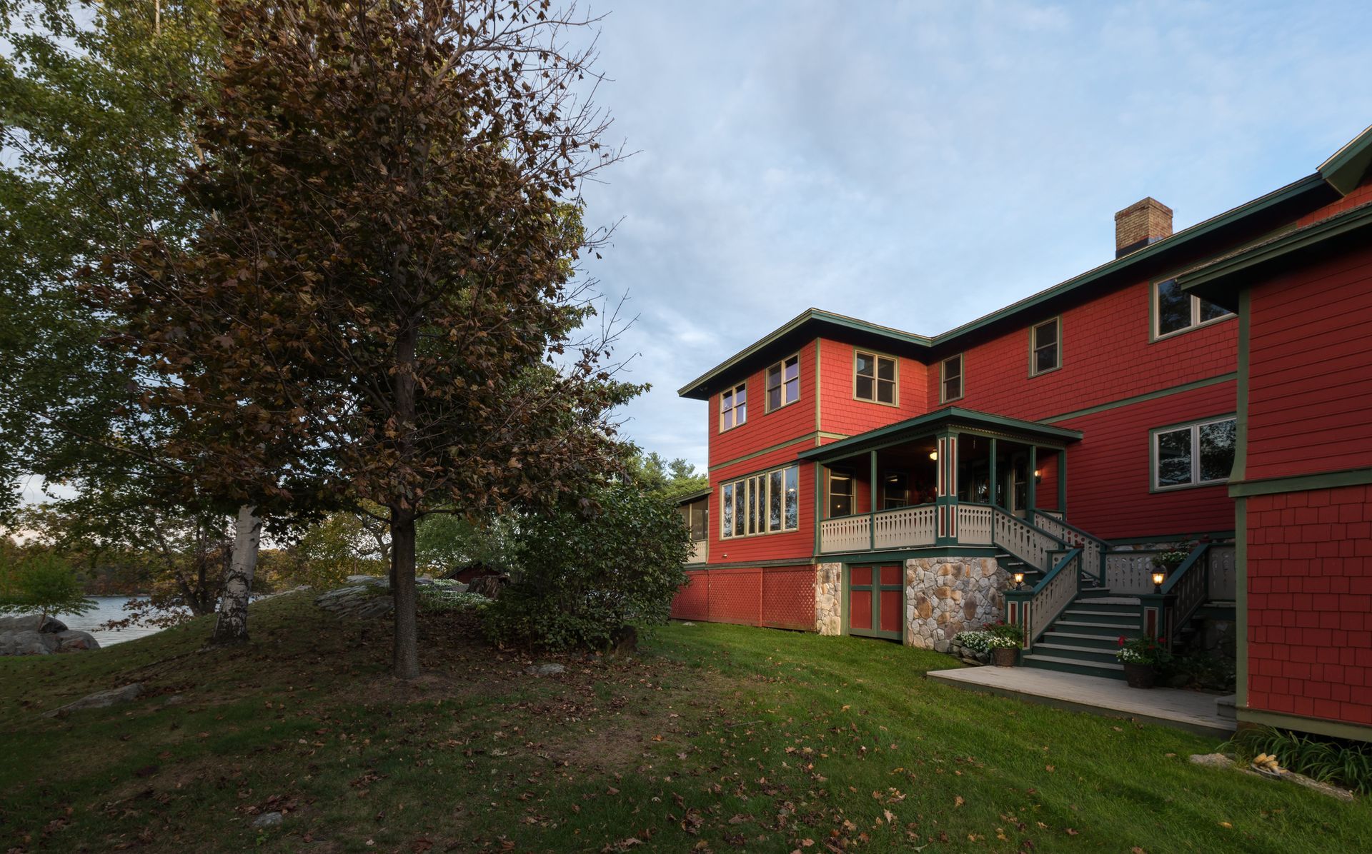 A large red house with a porch and stairs