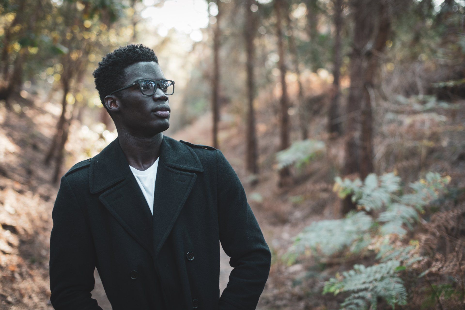 person wearing glasses in the woods