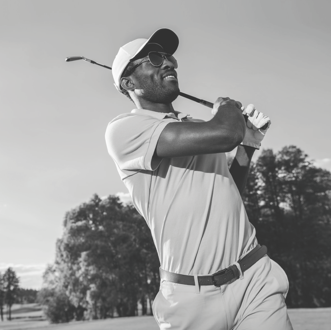 person golfing wearing sunglasses