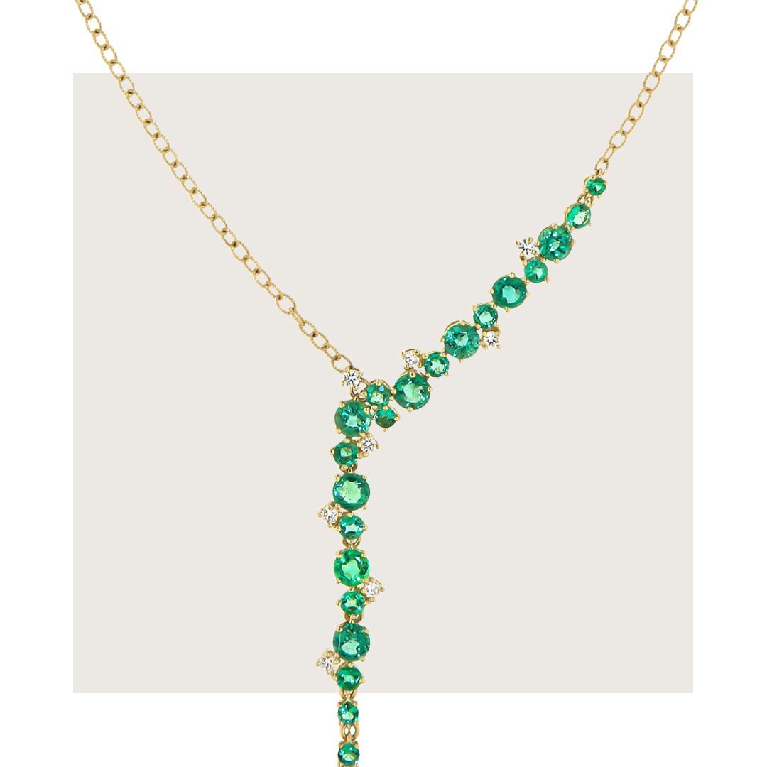Gouden ketting met smaragd- en diamantclusters.