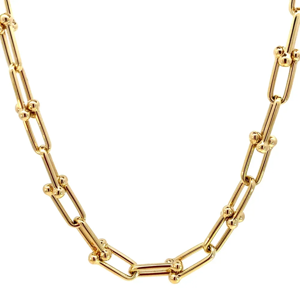 Goudkleurige schakelketting met rechthoekige schakels en kleine bolletjes op elke verbinding.