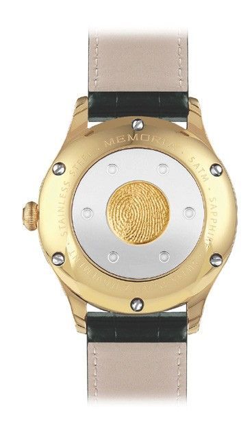 Achterkant van een gouden polshorloge met leren band. Het horloge heeft een ronde metalen achterkant met een getextureerd goudkleurig centraal element.