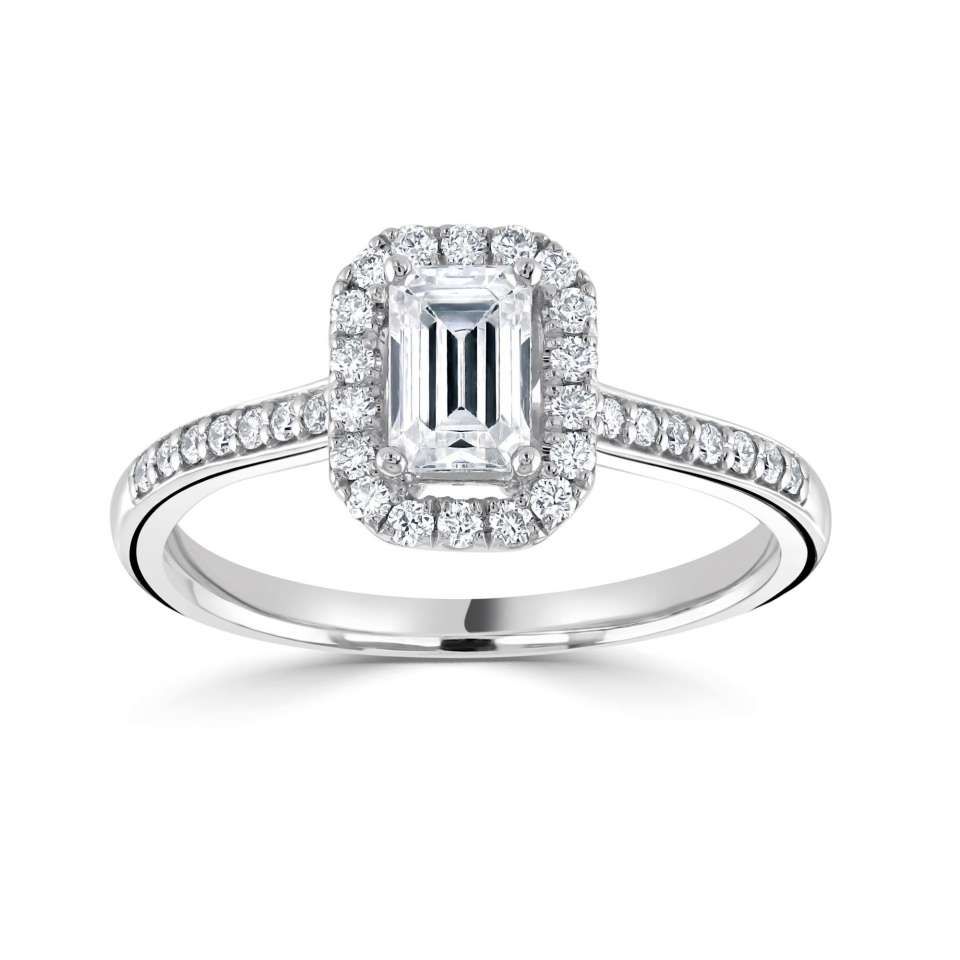 Verlovingsring met diamant en smaragdgeslepen middelste steen en halo, gezet op een dunne band met kleine diamanten.