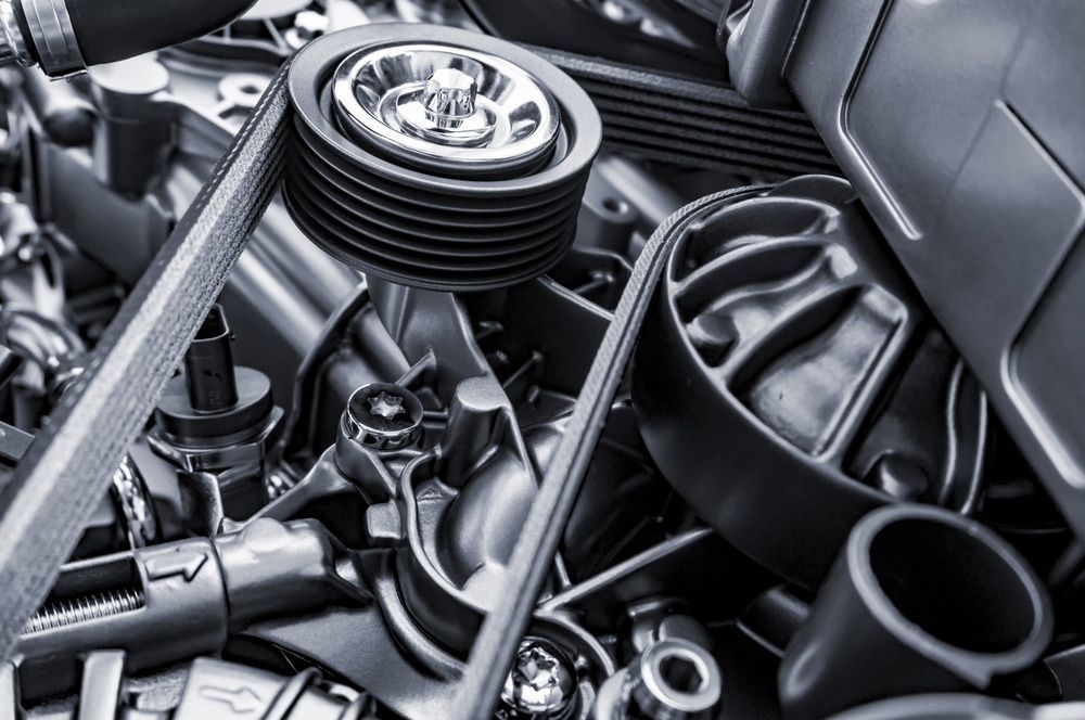 A Close Up Of a Car Engine with A Belt and Wrench — Currajong Brake Parts Pty Ltd In Currajong, QLD
