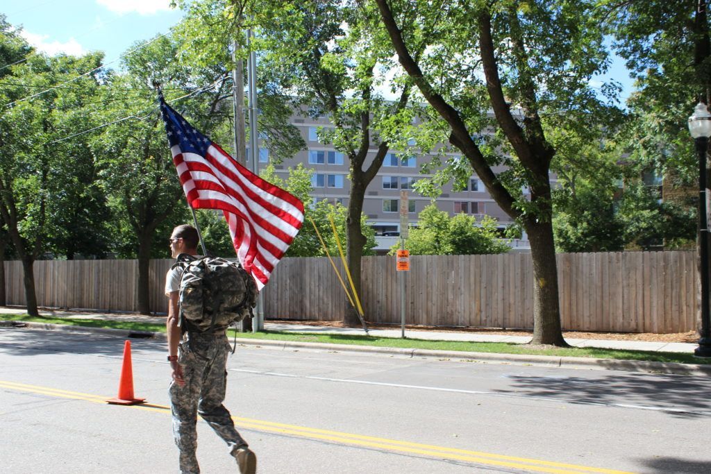 An inspiring athlete completes the IRONMAN Wisconsin run course in full military gear, to honor his fellow soldiers that lost their lives 15 years ago.